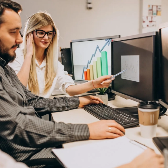 Workers at an IT company working on a computer